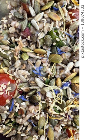 Phone photo of a vegetable salad topped with grains and dried flowers. Healthy gourmet dish showing vibrant colors, texture, and creative plating. Phone photo of a vegetable salad topped with grains and dried flowers. Healthy gourmet dish showing vibrant colors, texture, and creative plating. 139074532