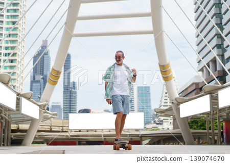 Cheerful senior Caucasian man with beard and glasses rides longboard along Skywalk in downtown district. Focusing on active retirement lifestyle and urban tourism. Concept of joyful aging and vacation Cheerful senior Caucasian man with beard and glasses rides longboard along Skywalk in downtown district. Focusing on active retirement lifestyle and urban tourism. Concept of joyful aging and vacation 139074670