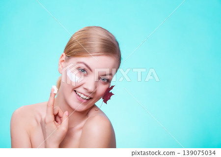 Skin care. Face of young woman girl with red maple leaf. 139075034
