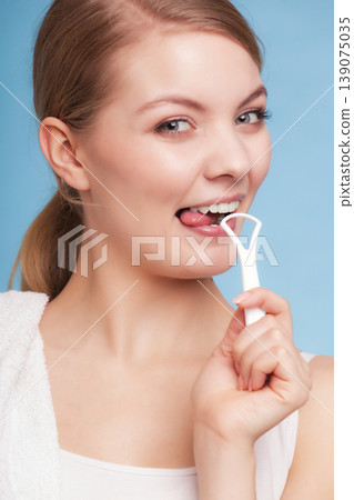 Girl cleaning tongue. Dental care oral hygiene. Girl cleaning tongue. Dental care oral hygiene. 139075035
