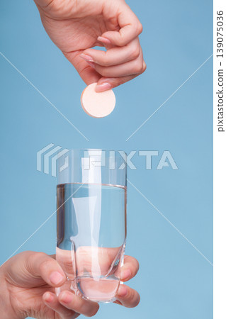 Aspirin pill tablet and glass water for headache 139075036