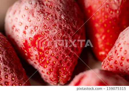 Frosty, thawing, bright red strawberries: ultimate macro close-up Frosty, thawing, bright red strawberries: ultimate macro close-up 139075315