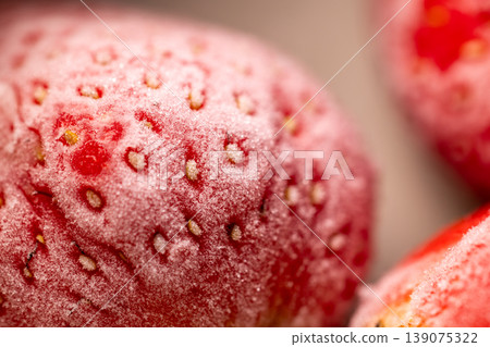 Frosty, thawing, bright red strawberries: ultimate macro close-up Frosty, thawing, bright red strawberries: ultimate macro close-up 139075322