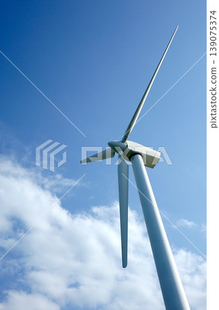 Wind power generator rising in blue sky Wind power generator rising in blue sky 139075374