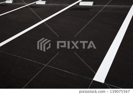 Close-up of the brand new parking lot surface and white lines Close-up of the brand new parking lot surface and white lines 139075567