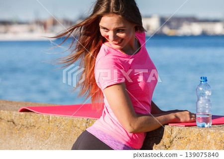 Woman drinking water after sport gym outdoor Woman drinking water after sport gym outdoor 139075840