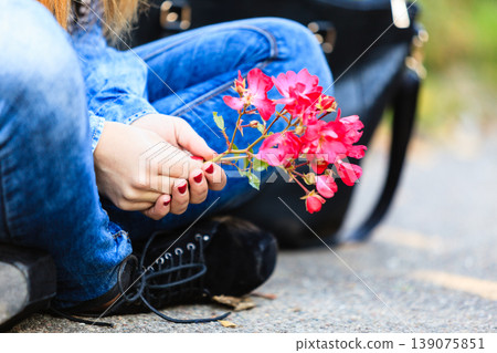 Woman with pink flower in garden. Woman with pink flower in garden. 139075851