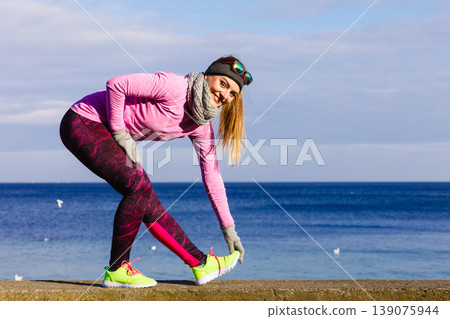Woman fitness sport girl training outdoor in cold weather Woman fitness sport girl training outdoor in cold weather 139075944