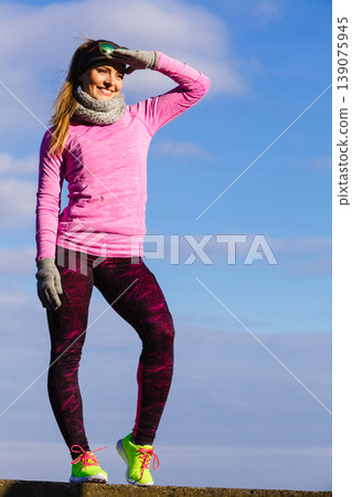 Woman resting after doing sports outdoors on cold day Woman resting after doing sports outdoors on cold day 139075945