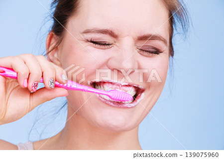 Woman brushing cleaning teeth Woman brushing cleaning teeth 139075960