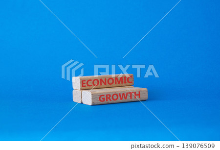 Economic stability symbol. Concept word Economic stability on wooden blocks. Beautiful blue background. Business and Economic stability concept. Copy space Economic stability symbol. Concept word Economic stability on wooden blocks. Beautiful blue background. Business and Economic stability concept. Copy space 139076509