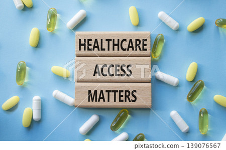 Healthcare Access Matters symbol. Concept words Healthcare Access Matters on wooden blocks. Beautiful blue background with pills. Healthcare and Healthcare Access Matters concept. Copy space. 139076567