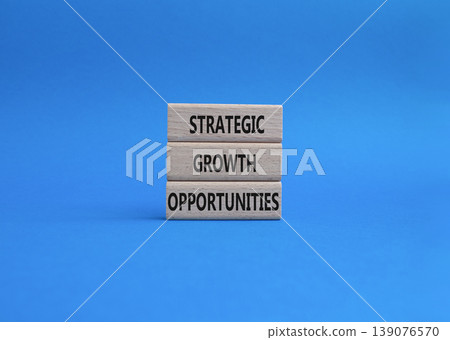 Strategic Growth Opportunities symbol. Concept word Strategic Growth Opportunities on wooden blocks. Beautiful blue background. Business and Strategic Growth Opportunities. Copy space Strategic Growth Opportunities symbol. Concept word Strategic Growth Opportunities on wooden blocks. Beautiful blue background. Business and Strategic Growth Opportunities. Copy space 139076570