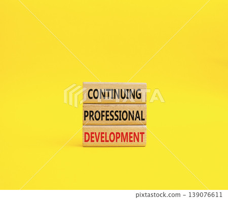 Continuing Development symbol. Concept words Continuing Professional Development on wooden blocks. Beautiful yellow background. Business and Development concept. Copy space 139076611