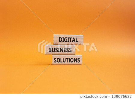 Digital Business Solutions symbol. Concept word Digital Business Solutions on wooden blocks. Beautiful orange background. Business and Digital Business Solutions. Copy space 139076622