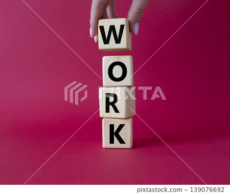 Work symbol. Concept word Work on wooden cubes. Businessman hand. Beautiful blue background. Business and Work concept. Copy space. Work symbol. Concept word Work on wooden cubes. Businessman hand. Beautiful blue background. Business and Work concept. Copy space. 139076692