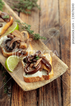 Sandwiches with baked mushrooms on an old wooden table. Sandwiches with baked mushrooms on an old wooden table. 139076840