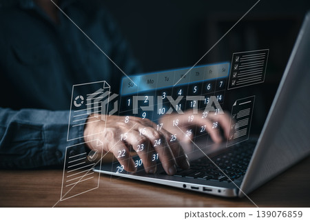 A person typing on a laptop with a digital hologram calendar and task list interface, symbolizing online scheduling, time management, productivity, and business organization in modern technology. A person typing on a laptop with a digital hologram calendar and task list interface, symbolizing online scheduling, time management, productivity, and business organization in modern technology. 139076859