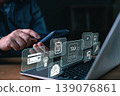 A person using smartphone and laptop with digital tax and finance icons, representing online tax payment, financial management, e-invoice, and digital accounting technology. 139076861
