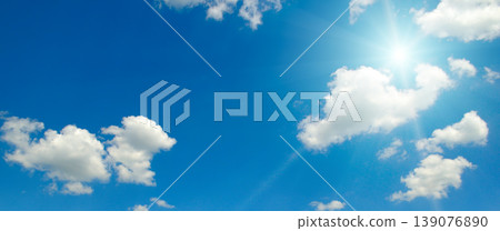 Clear blue sky with white fluffy clouds and bright radiant sun. Clear blue sky with white fluffy clouds and bright radiant sun. 139076890