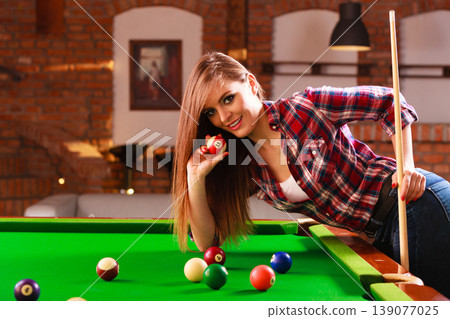 Young woman having fun with billiard. Young woman having fun with billiard. 139077025