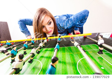 woman playing table football game woman playing table football game 139077029
