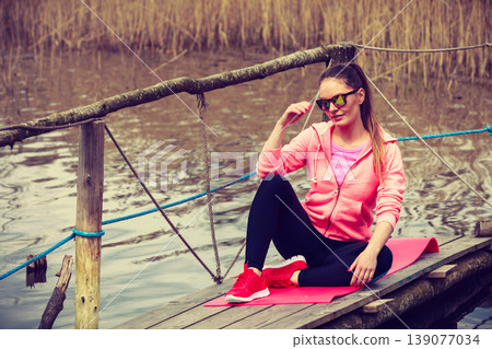 Young sports woman taking break after a run. Young sports woman taking break after a run. 139077034