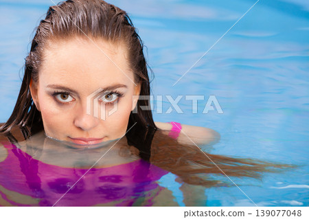 Woman having fun in swimming pool Woman having fun in swimming pool 139077048