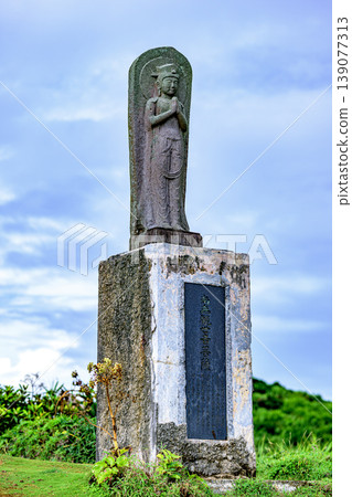 The statue of Kannon Bodhisattva at Cape Goshinzaki stands quietly beneath the blue sky. The statue of Kannon Bodhisattva at Cape Goshinzaki stands quietly beneath the blue sky. 139077313