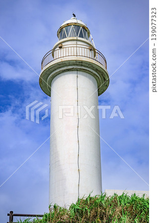 The beautiful sight of the Ishigaki Island Ogamisaki Lighthouse standing tall against the blue sky. The beautiful sight of the Ishigaki Island Ogamisaki Lighthouse standing tall against the blue sky. 139077323