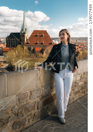 Woman Standing at Scenic European Viewpoint with Historic Church Woman Standing at Scenic European Viewpoint with Historic Church 139077499