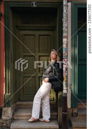 Fashion Portrait of Woman Standing by Historic Doorway 139077505