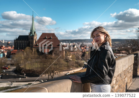Woman Standing at Scenic European Viewpoint with Historic Church Woman Standing at Scenic European Viewpoint with Historic Church 139077522