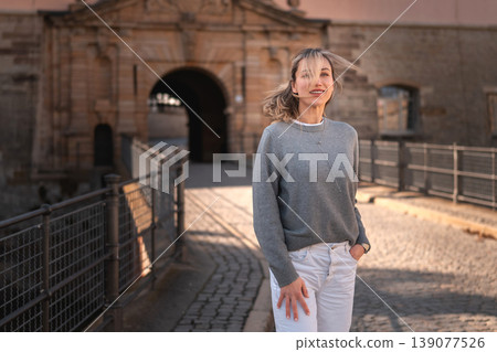 Happy Woman Walking in Historic European Old Town Happy Woman Walking in Historic European Old Town 139077526
