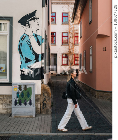Woman Walking Through Narrow Historic Alley by Street Art Woman Walking Through Narrow Historic Alley by Street Art 139077529