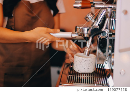 Young woman at barista school learning how to make espresso coffee. 139077558