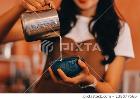 Young woman at barista school learning how to make espresso coffee. 139077560