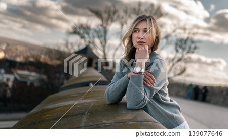 Young Woman Resting Chin on Hand at Scenic Stone Viewpoint Young Woman Resting Chin on Hand at Scenic Stone Viewpoint 139077646
