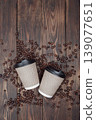 dark plank background, hot take-away coffee on a wooden table, coffee beans . top view, copyspace. 139077651