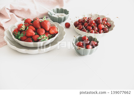Strawberries and Red Cherries with Sugar Bowl on White Table Strawberries and Red Cherries with Sugar Bowl on White Table 139077662