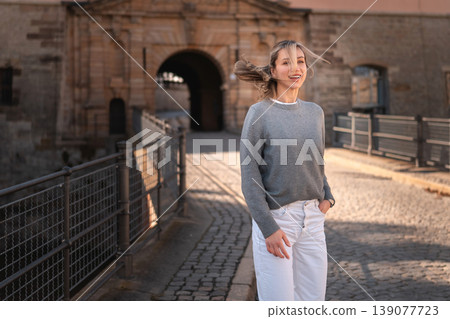 Happy Woman Walking Near Historic European Gate Happy Woman Walking Near Historic European Gate 139077723