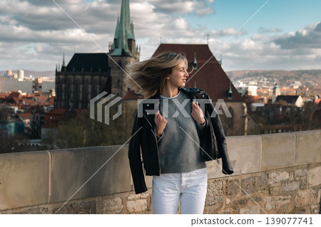 Woman Turning with Windblown Hair at Scenic European Viewpoint Woman Turning with Windblown Hair at Scenic European Viewpoint 139077741