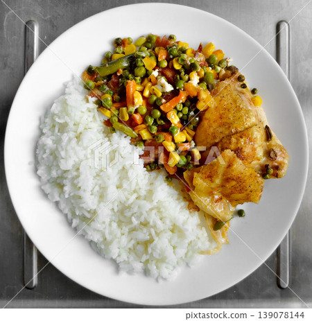 Chicken and rice with mixed vegetables on white plate 139078144