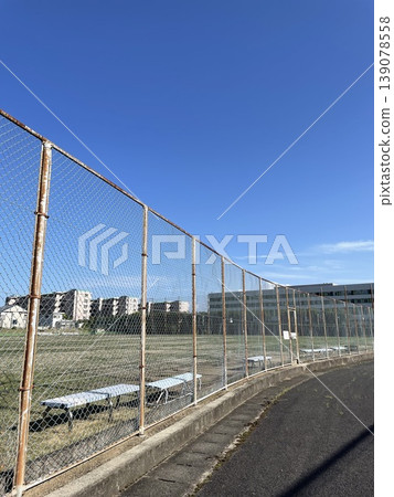 The field beyond the fence, where no one is around. The field beyond the fence, where no one is around. 139078558