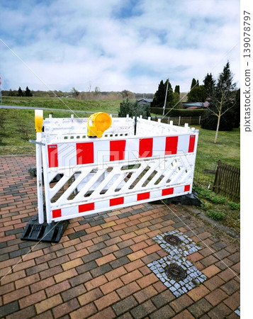The pedestrian area is equipped with plastic protective barriers with flashing yellow lights on sunny days. The pedestrian area is equipped with plastic protective barriers with flashing yellow lights on sunny days. 139078797