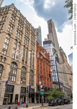 New york, usa august 15,2024. Manhattan streetscape featuring a blend of historic and modern towering buildings, showcasing diverse architectural styles under a cloudy sky New york, usa august 15,2024. Manhattan streetscape featuring a blend of historic and modern towering buildings, showcasing diverse architectural styles under a cloudy sky 139078810