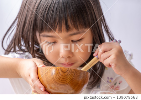 A little girl eating A little girl eating 139079568