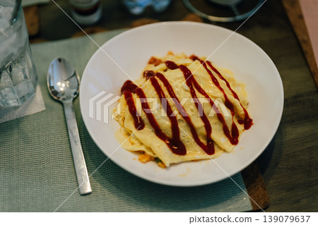 Homemade omelet rice with ketchup and cutlery 139079637