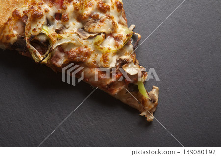 Slice of Mixed Pizza on Granite Surface Slice of Mixed Pizza on Granite Surface 139080192