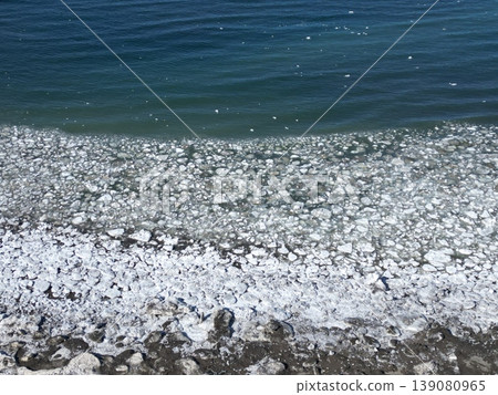 Aerial view of the coastline along the scenic byway with remaining drift ice. Aerial view of the coastline along the scenic byway with remaining drift ice. 139080965